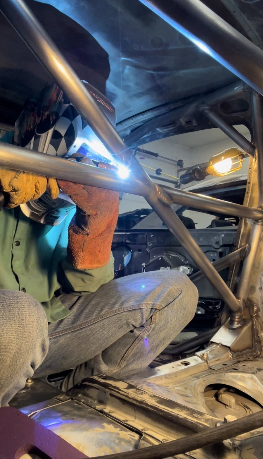 Welding a roll cage inside a car