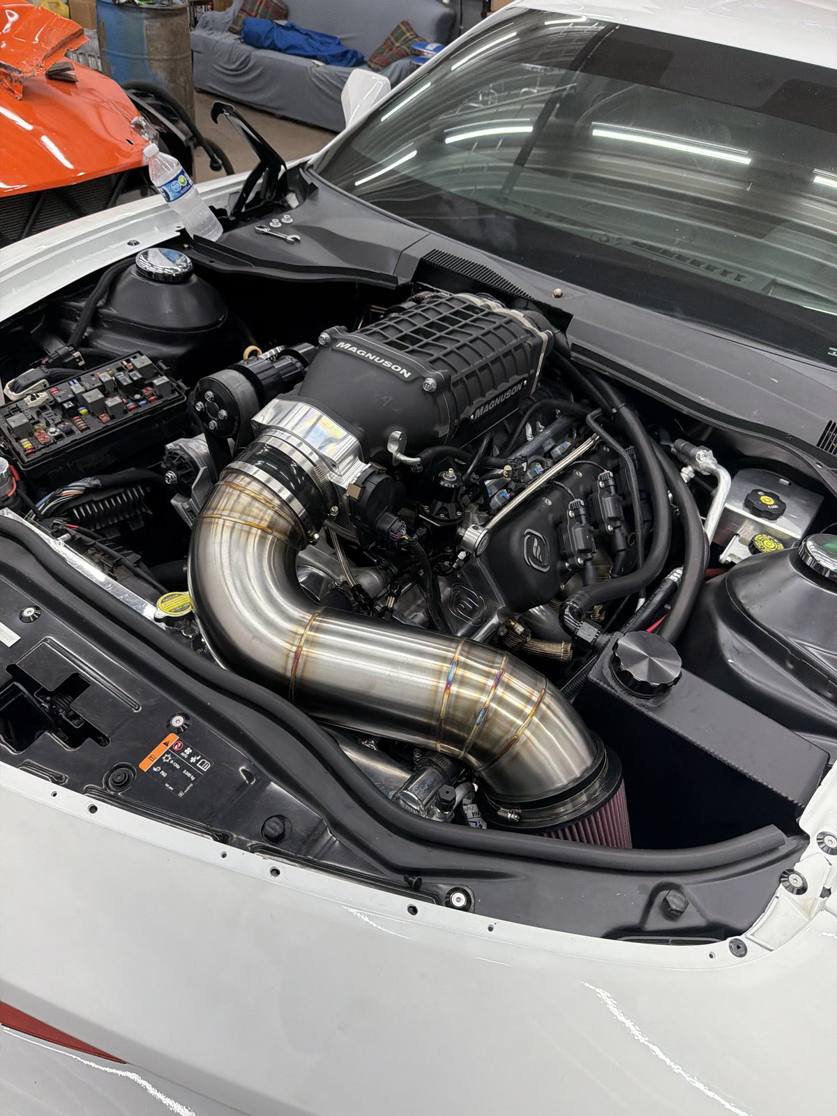 Custom stainless intake tube on a supercharged engine